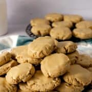 A plate of glazed maple brown sugar cookies with cookies in the background.