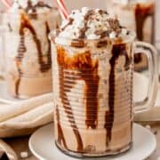A glass of frozen hot chocolate with a red and white straw.