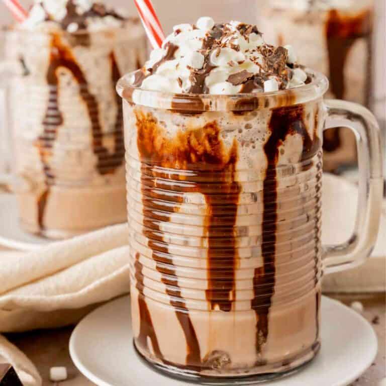 A glass of frozen hot chocolate with a red and white straw.