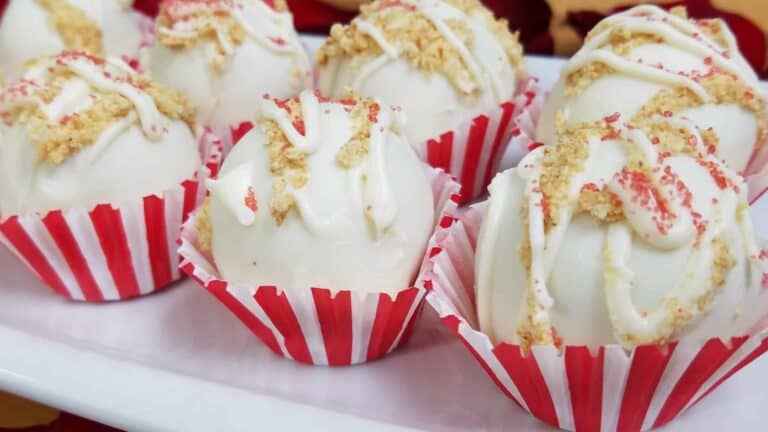 Strawberry Cheesecake Sweetheart Truffles topped with graham cracker crumbs and white chocolate.