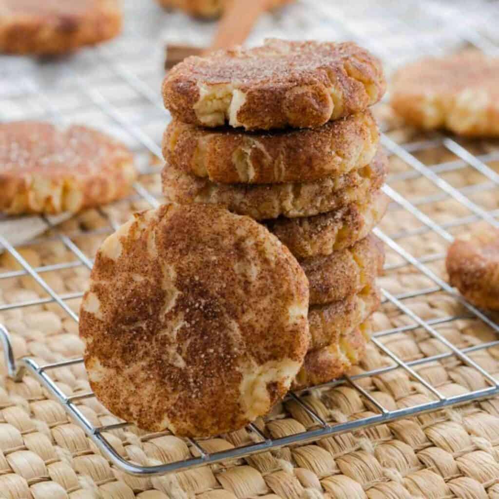 A stack of brown butter sugar cookies on a cooling rack.