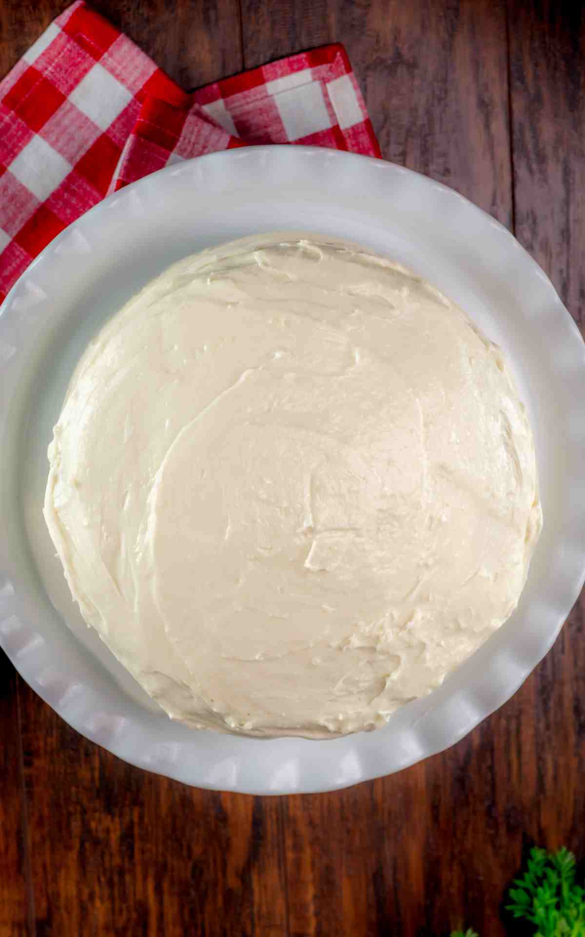 Top view of a classic carrot cake with cream cheese frosting.