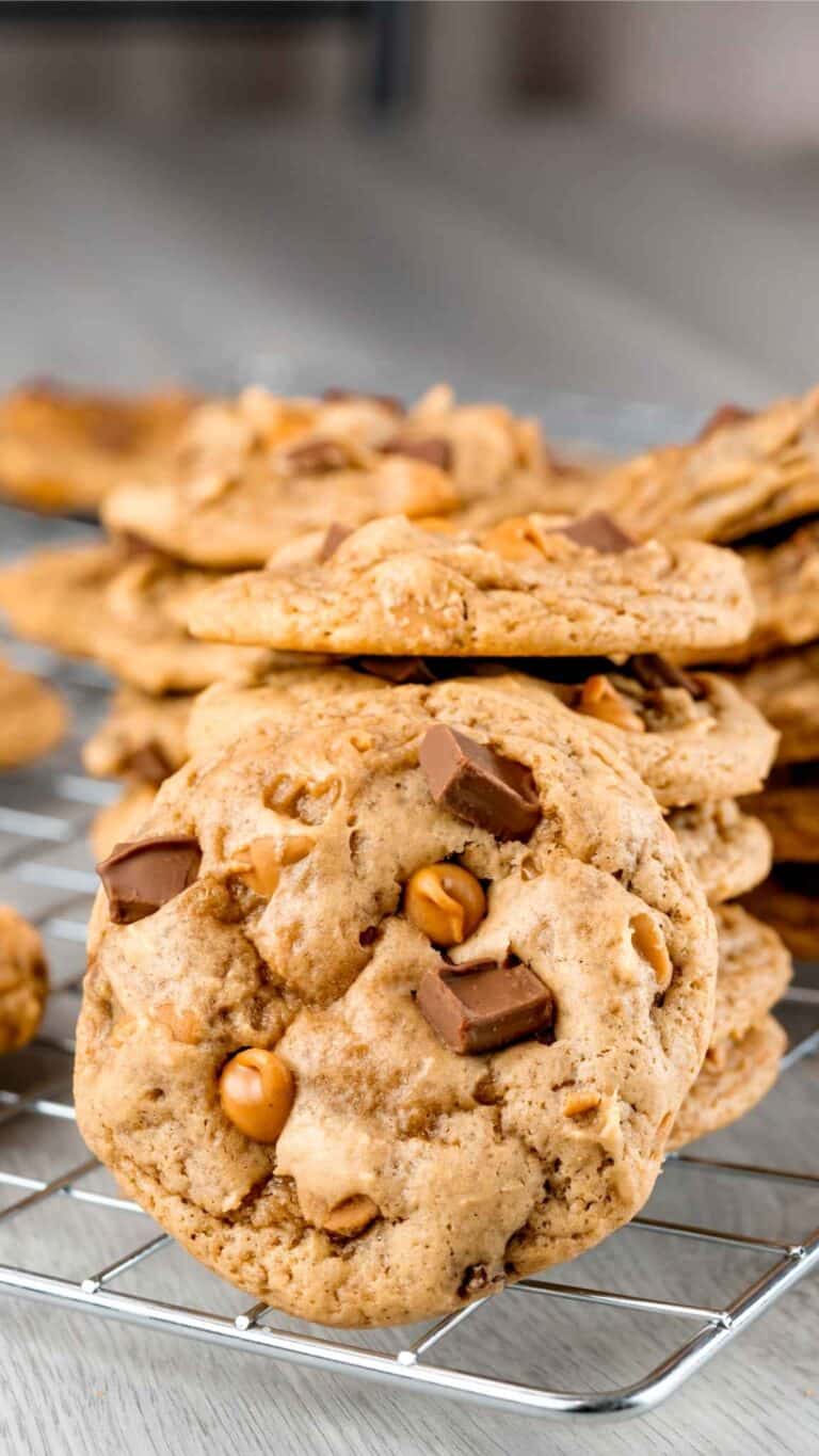Chocolate Chunk Peanut Butter Cookies stacked on a wire rack.