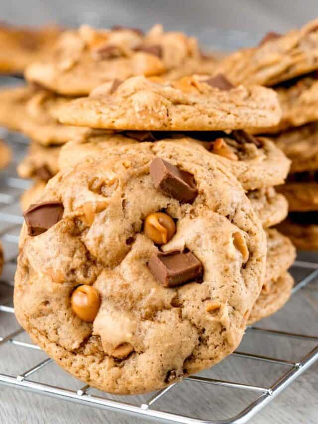 Chocolate Chunk Peanut Butter Cookies stacked on a wire rack.
