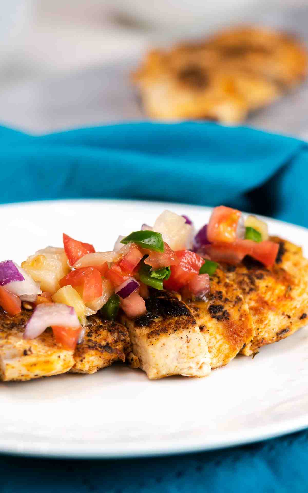 Blackened Chicken with pineapple pico de gallo on a plate.