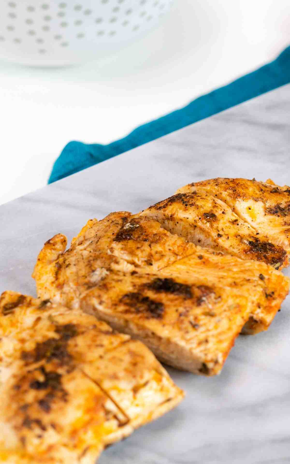 Easy blackened chicken sliced on a marble cutting board.