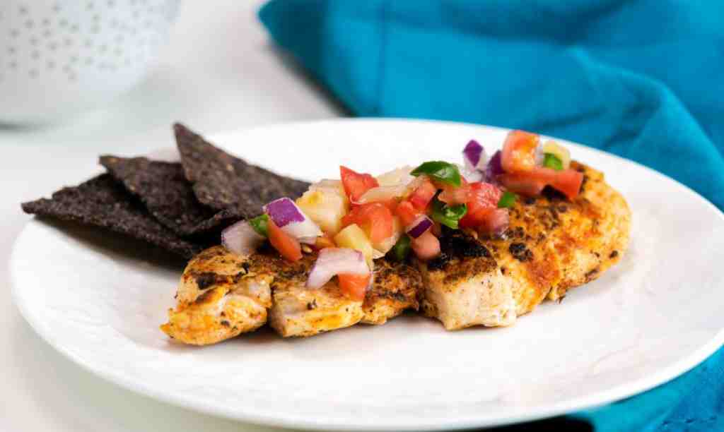 Skillet Blackened Chicken with pineapple pico de gallo and blue tortilla chips.