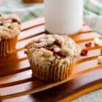 Cranberry Orange Oat Muffins with a glass of milk in the background.