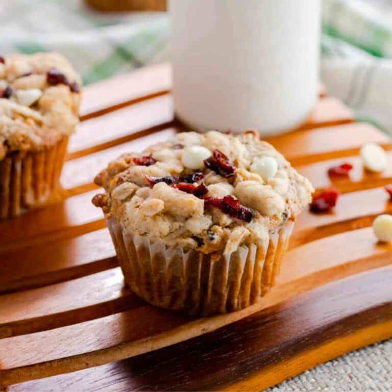 Cranberry Orange Oat Muffins with a glass of milk in the background.