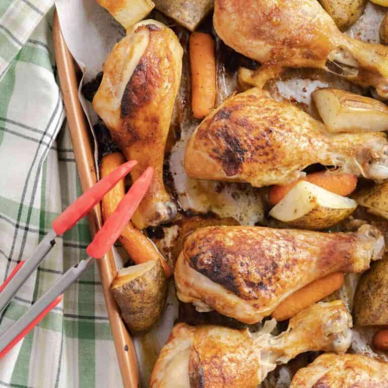 Sheet Pan Chicken Drumsticks and vegetables on a copper sheet pan.