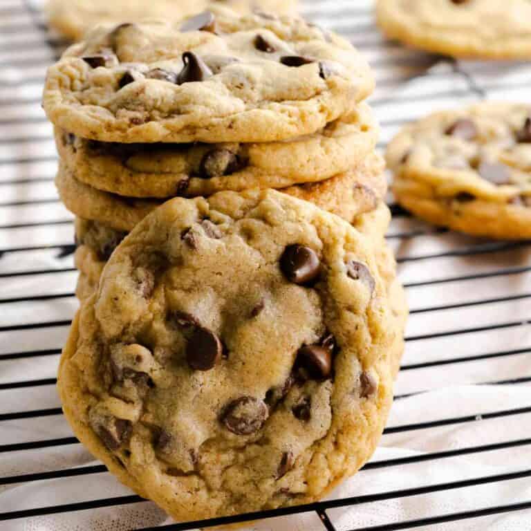 Mrs Fields chocolate chip cookies copycat cookies stacked on a cooling rack.