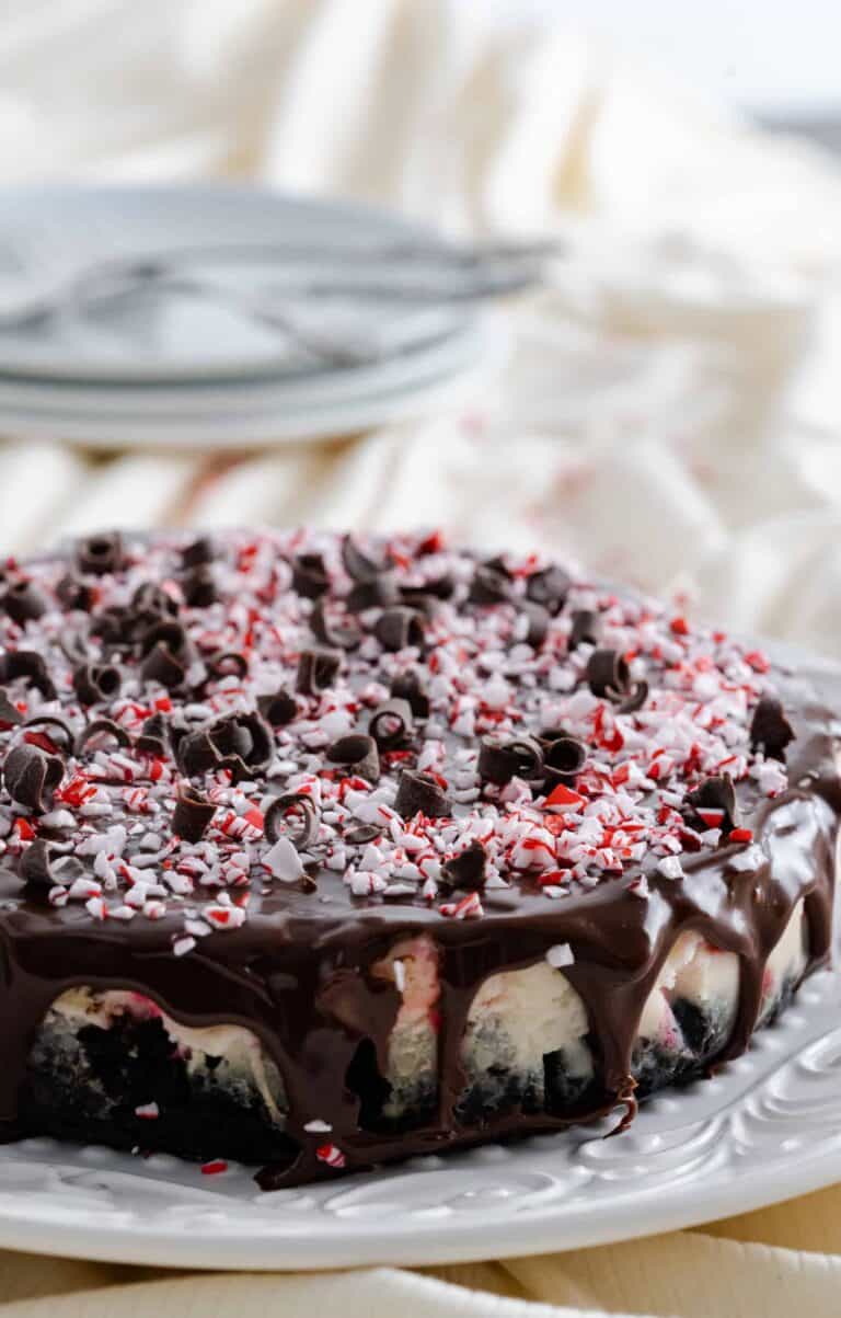 Instant Pot Peppermint Cheesecake garnished with peppermint candies and chocolate curls.