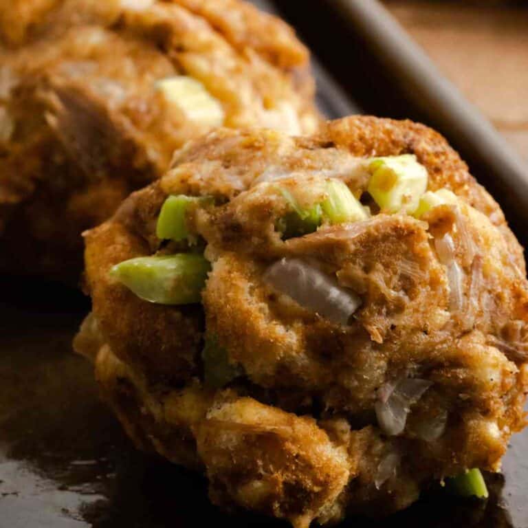 Close up of stuffing balls freshly baked for Thanksgiving on a baking sheet.