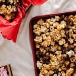 Caramel Chocolate Popcorn on a red baking sheet.