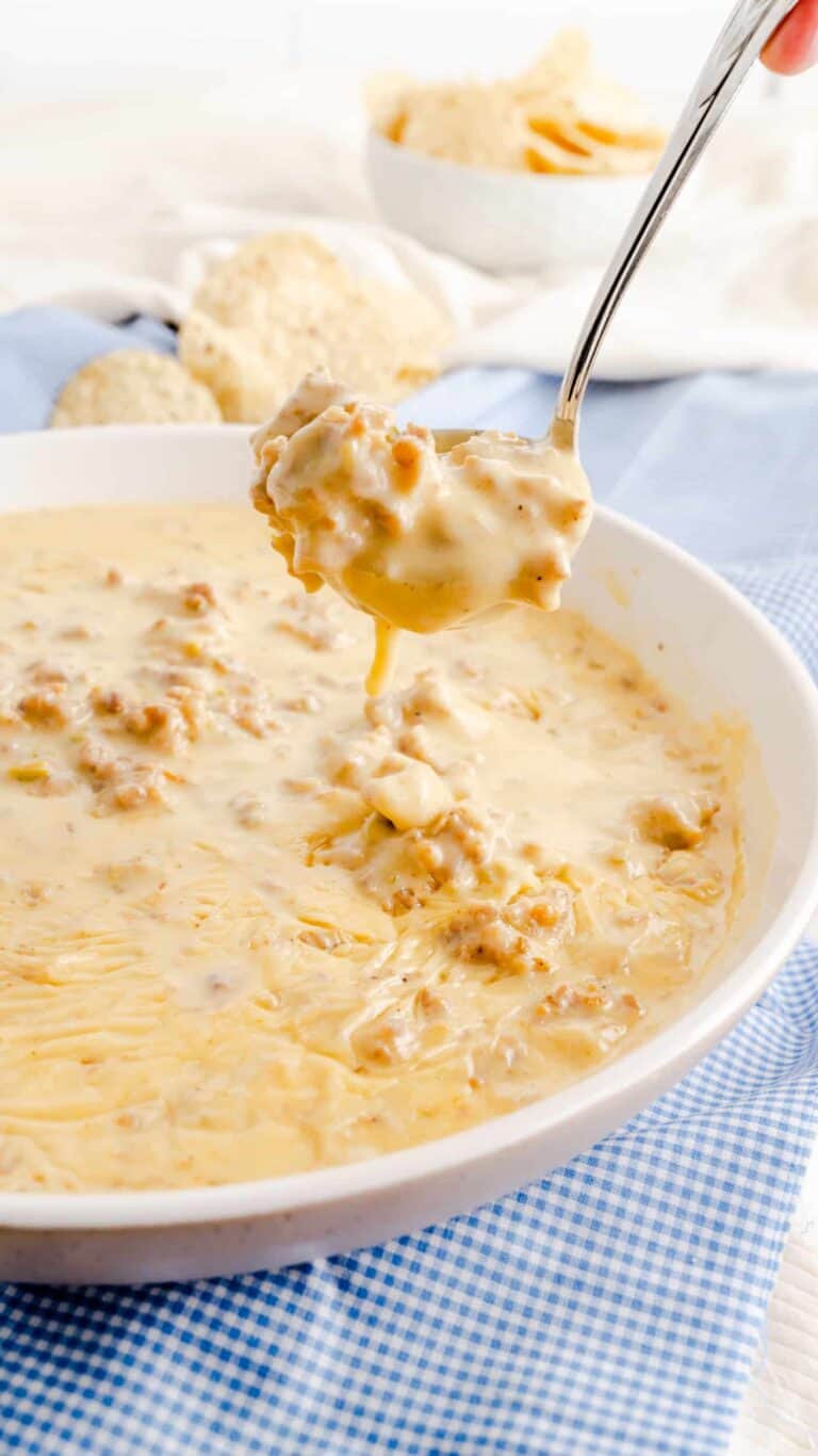 serving spoon of white queso cheese dip