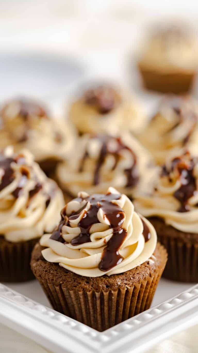 Chocolate gingerbread cupcakes with chocolate ganache drizzled on top of the frosting.