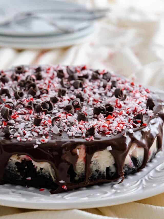 Instant Pot Peppermint Cheesecake garnished with peppermint candies and chocolate curls.