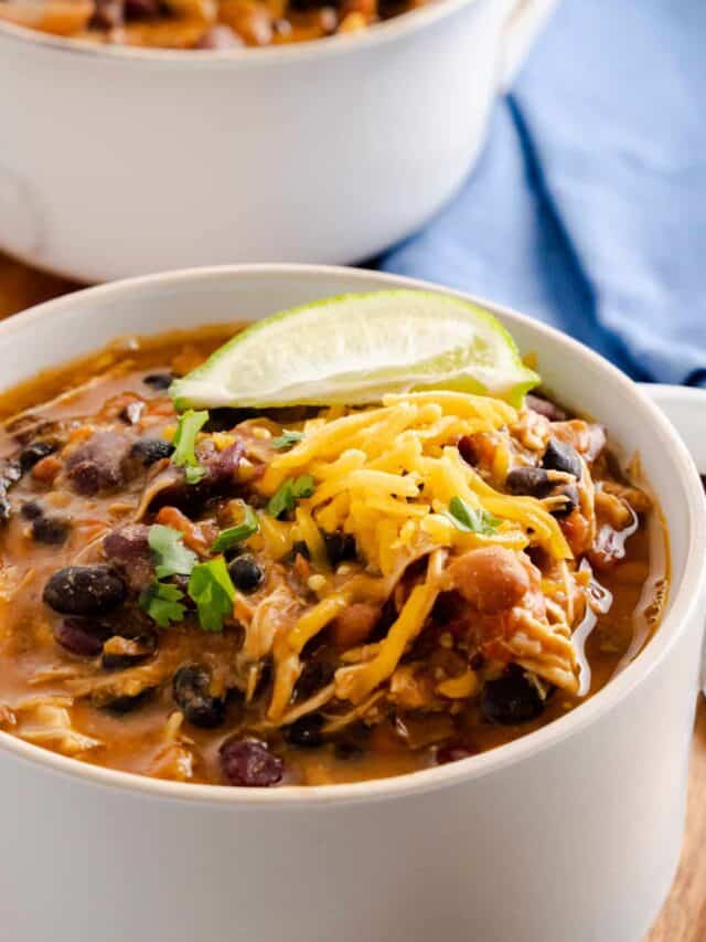 chicken chili topped with shredded cheese and lime wedge