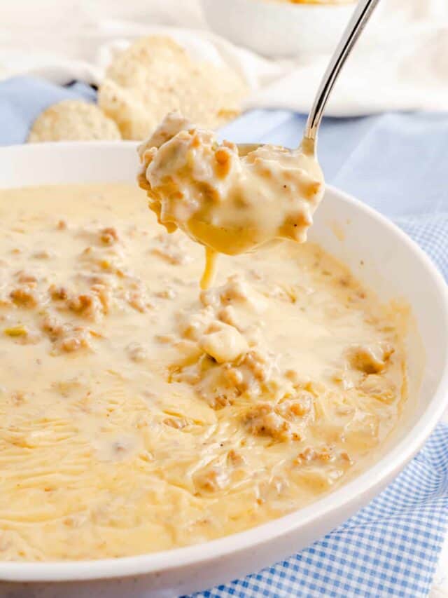 serving spoon of white queso cheese dip
