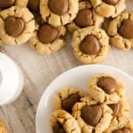a glass of milk with peanut butter cookies on white plate