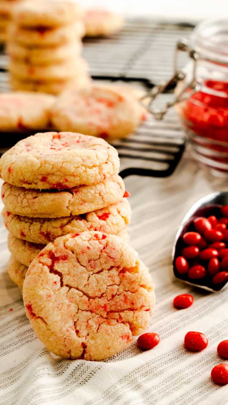 red hot cookies stacked with a scoop of red hot candies