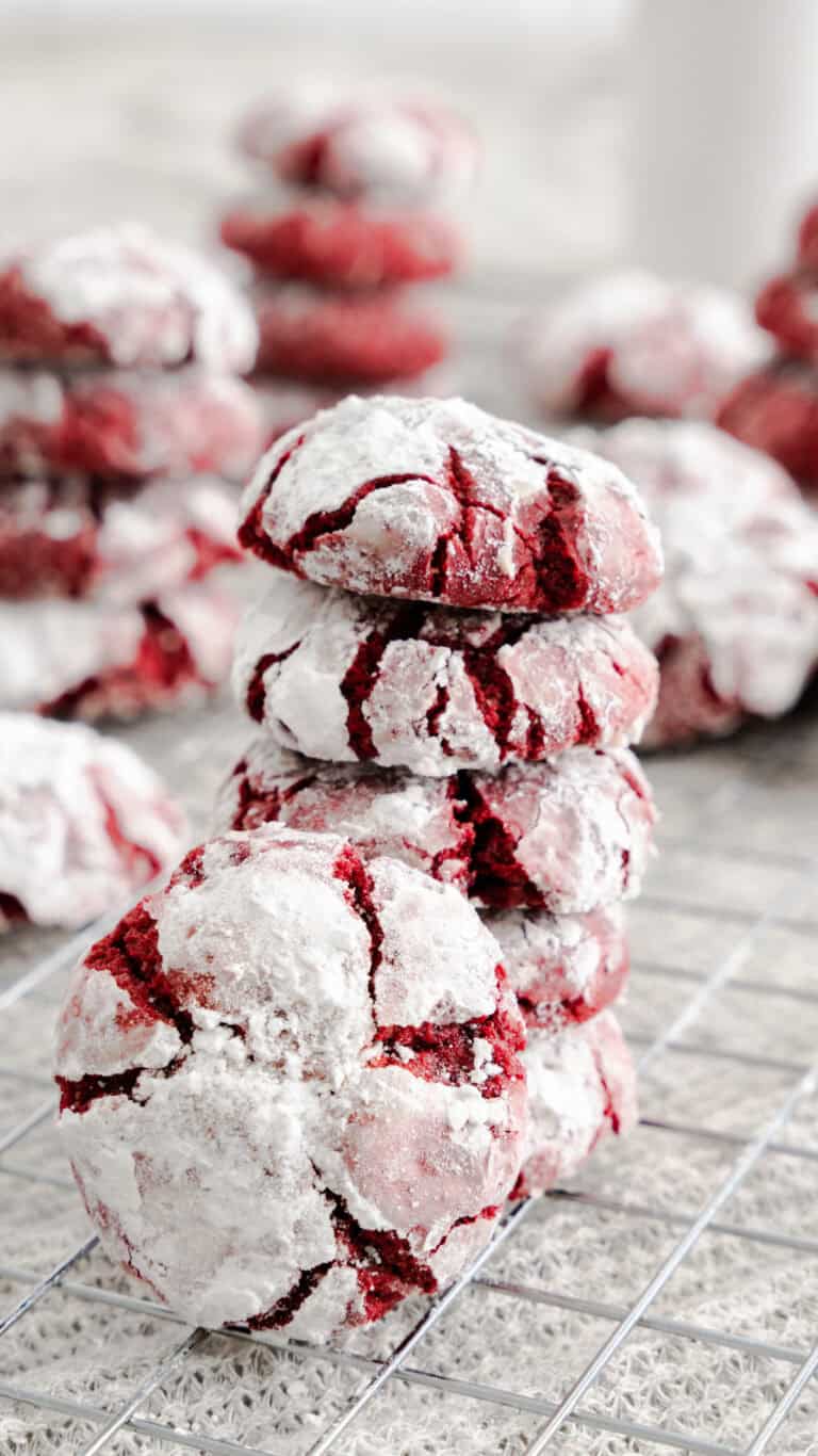 stacked red velvet crinkle cookies on wire rack