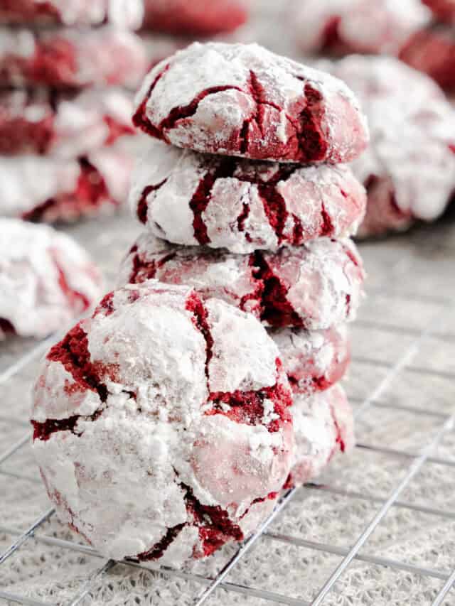 stacked red velvet crinkle cookies on wire rack