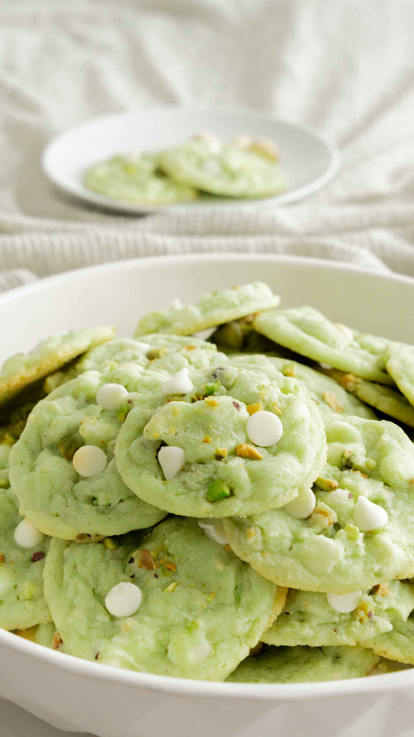 Platter of pistachio cookies in white bowl. 