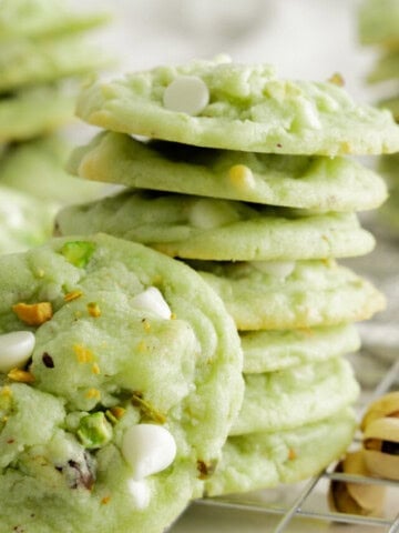 stack of pistachio cookies with cookie propped in front