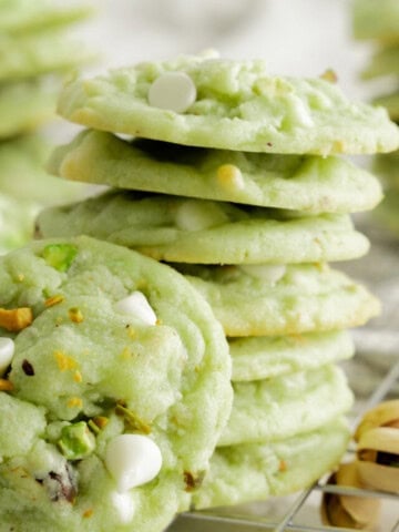 stack of pistachio cookies with cookie propped in front