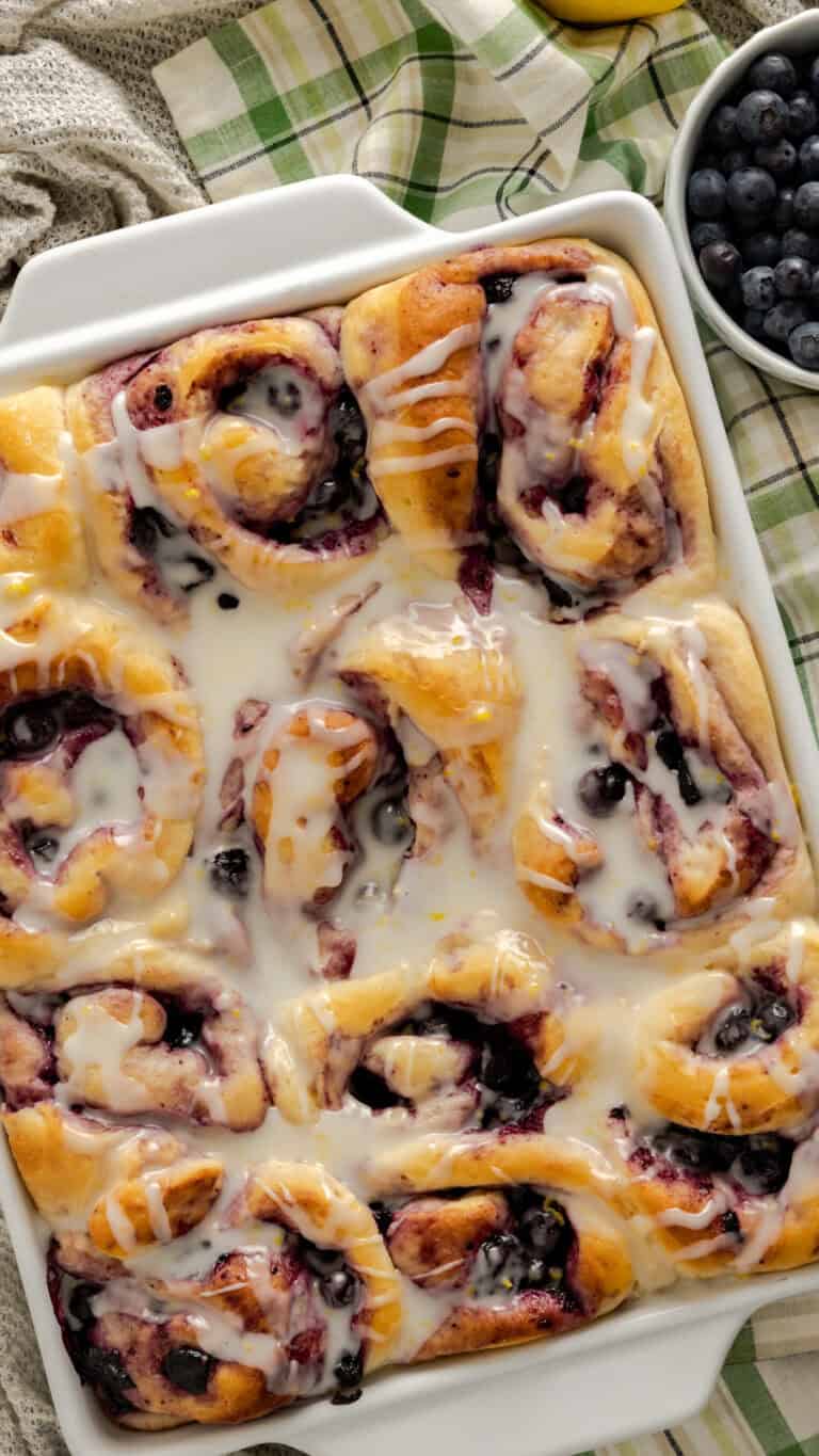 lemon blueberry sweet rolls in white casserole dish.
