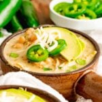 A bowl of Instant Pot Salsa Verde Chicken Chili with toppings.