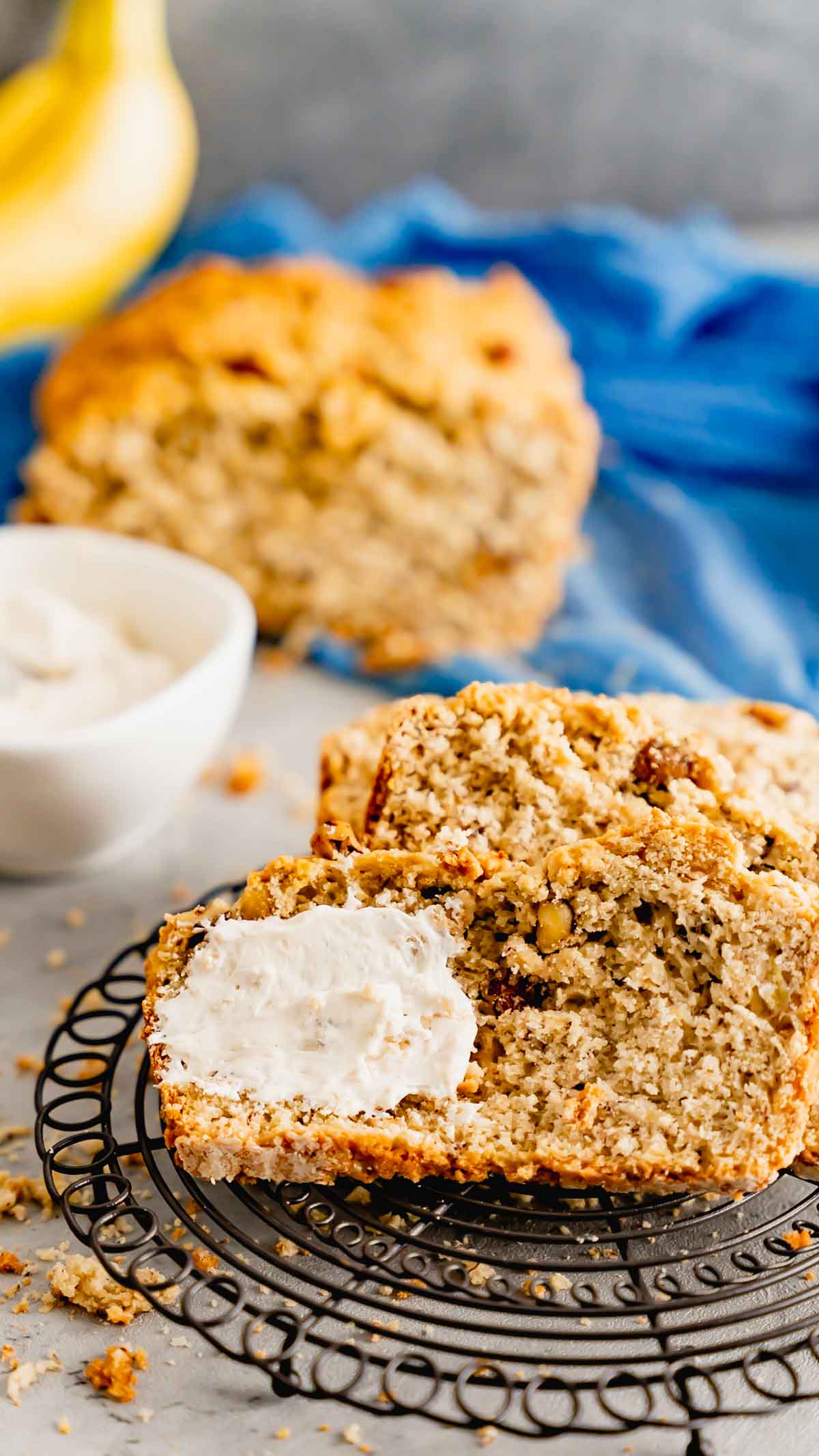 Betty White's Banana Bread with cinnamon cream cheese spread on round rack.