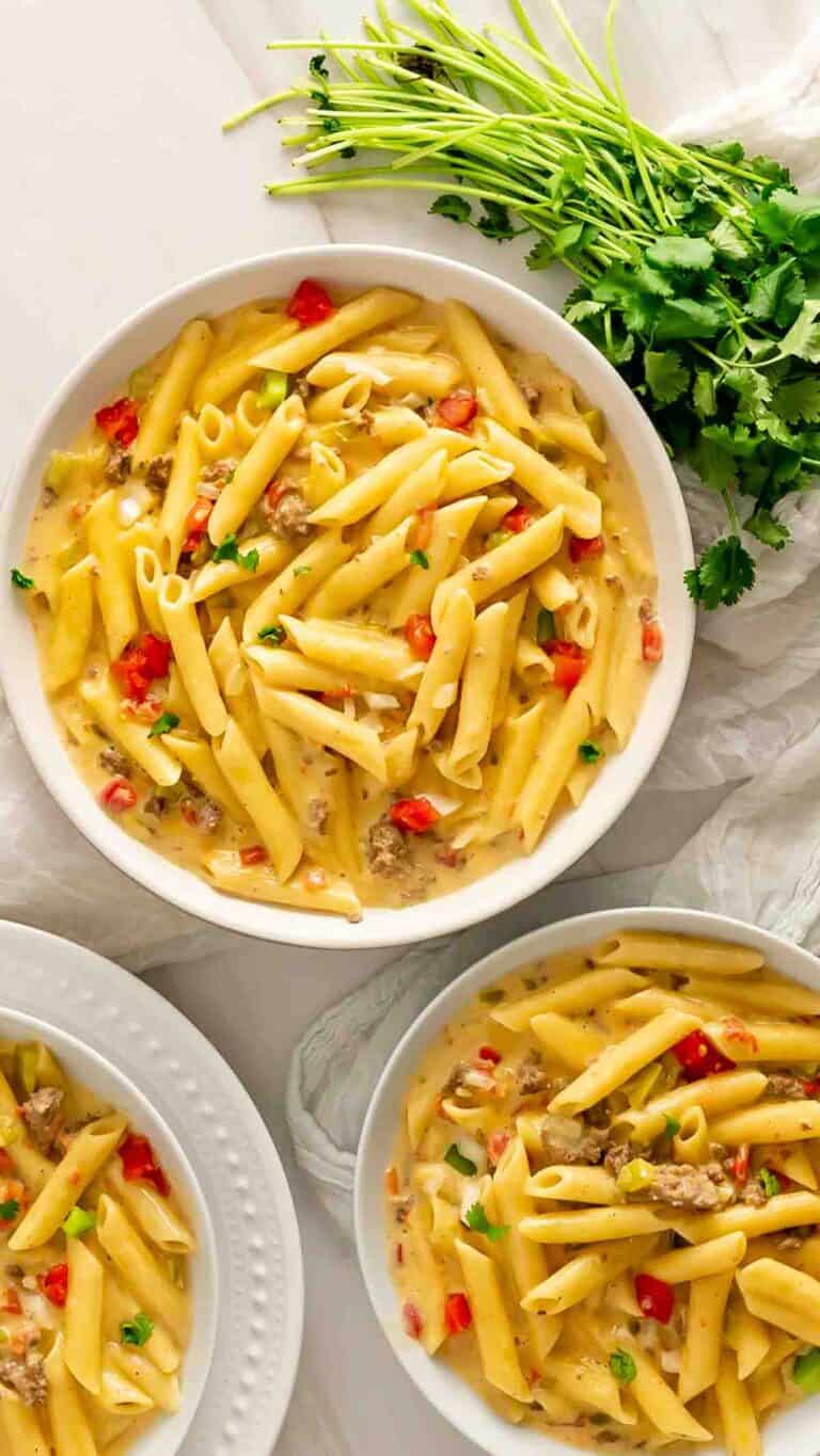 Three bowls of Instant Pot Rotel Pasta garnished with cilantro.