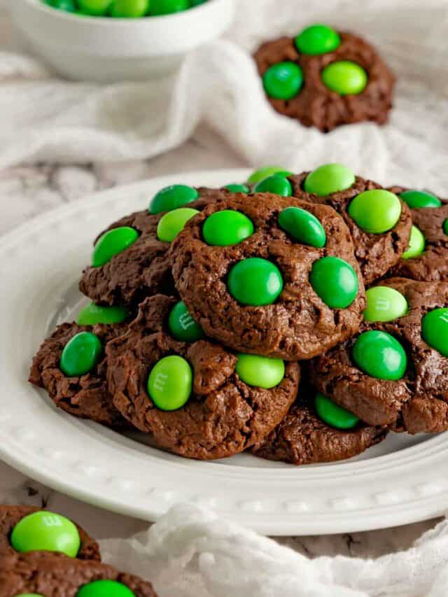 Mint chocolate cookies on a white platter with mint M&M's.