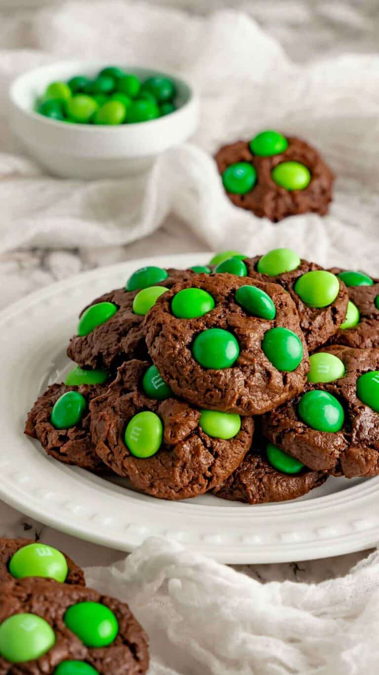 Mint chocolate cookies on a white platter with mint M&M's.