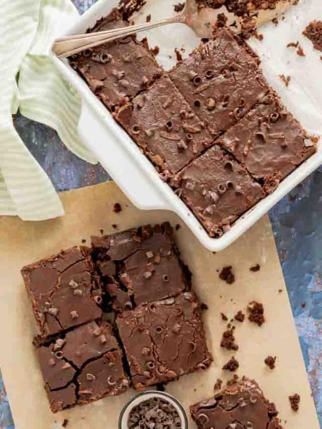 Coca Cola Cake squares topped with chocolate curls.