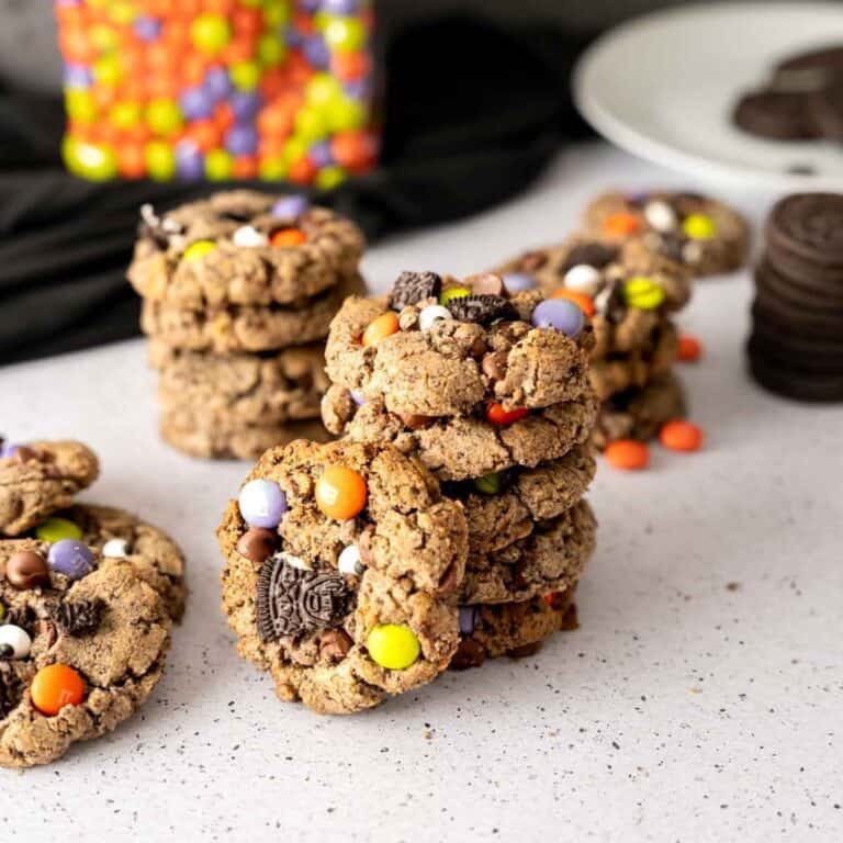 A stack of Halloween Cookies with a cookie propped next to the stack.