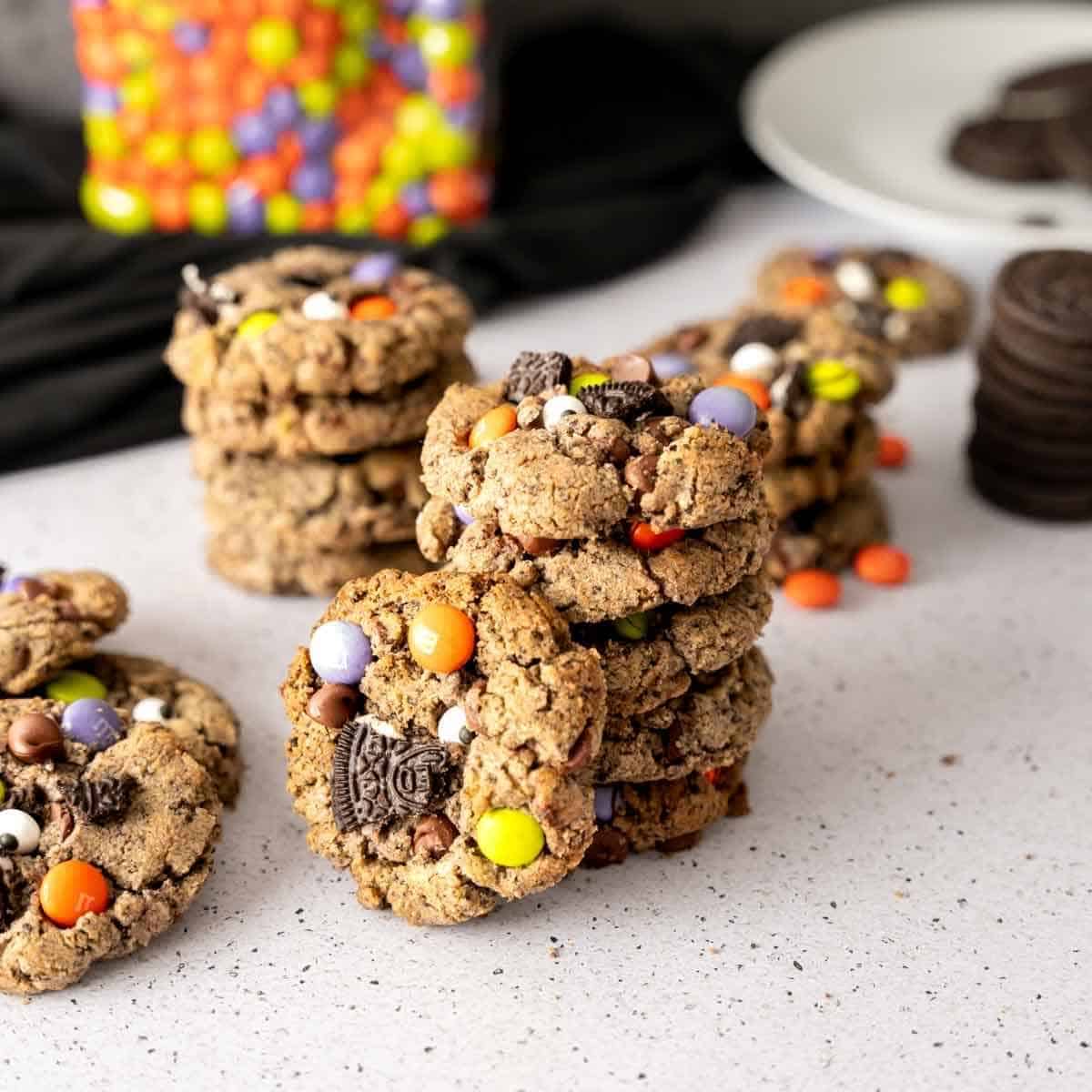 A stack of Halloween Cookies with a cookie propped next to the stack.