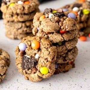 A stack of Halloween Cookies with a cookie propped next to the stack.