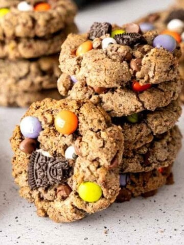 A stack of Halloween Cookies with a cookie propped next to the stack.