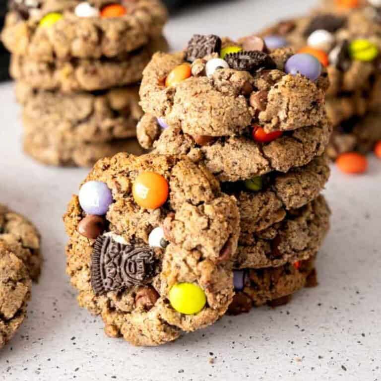 A stack of Halloween Cookies with a cookie propped next to the stack.