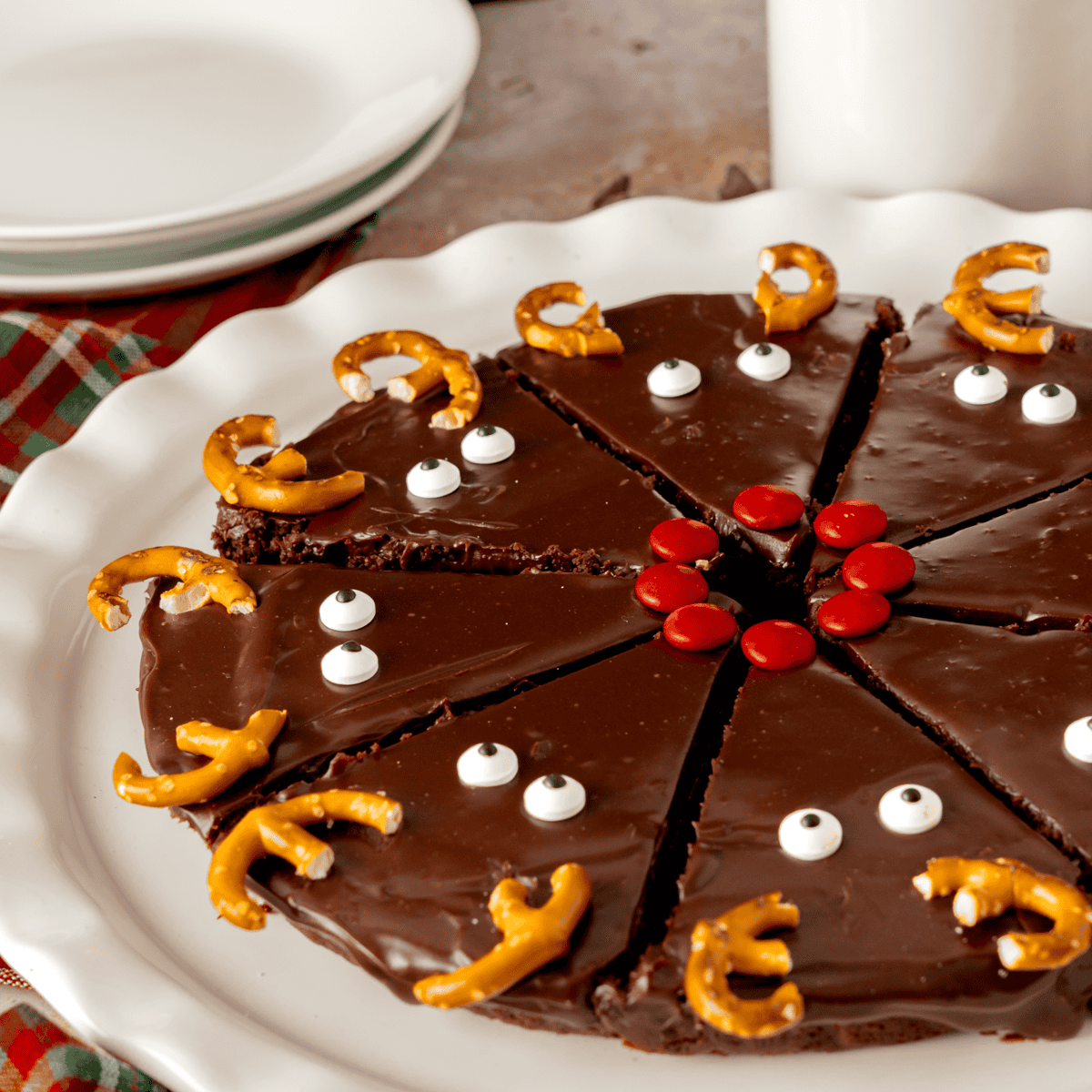 Fudgy Christmas brownies decorated with ganache with reindeer faces.