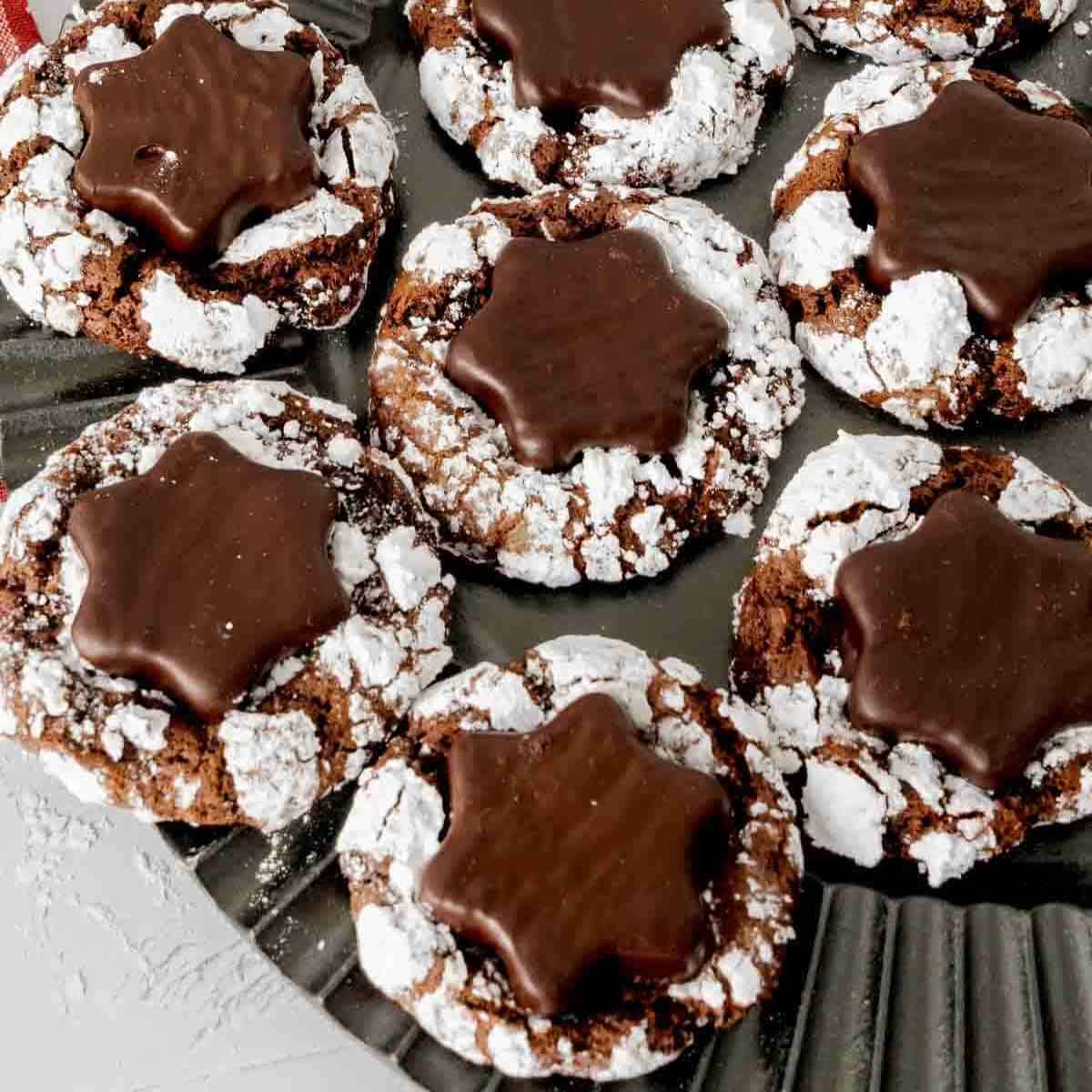 Peppermint Hot Cocoa Crinkle Cookies with a snowflake York peppermint patty pressed in the center.