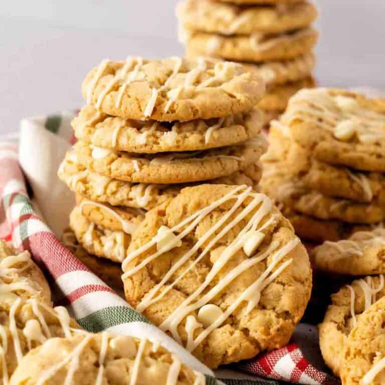 A stack of Peanut Butter Maple Cookies drizzled with maple icing.
