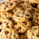 Chocolate Chip Cookie Butter Cookies stacked on top of each other with a white background.