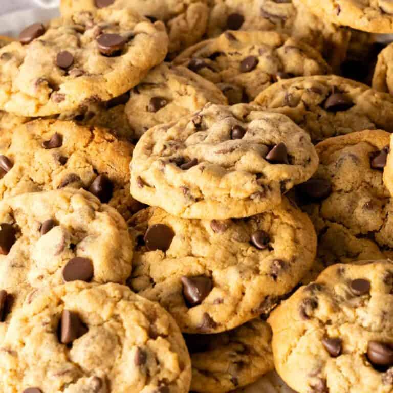 Chocolate Chip Cookie Butter Cookies stacked on top of each other with a white background.