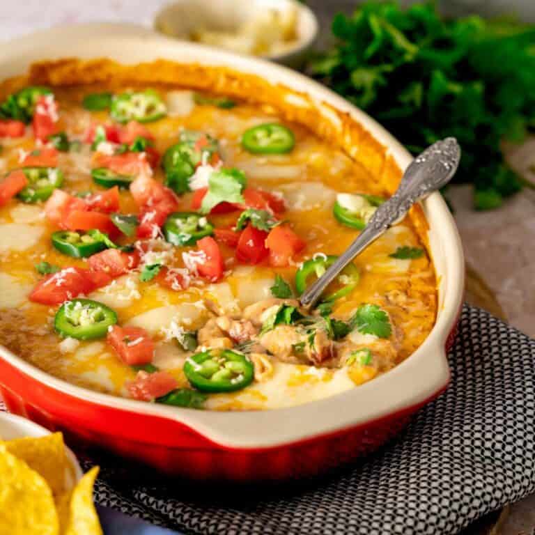 A serving spoon in a baking dish of bean dip.