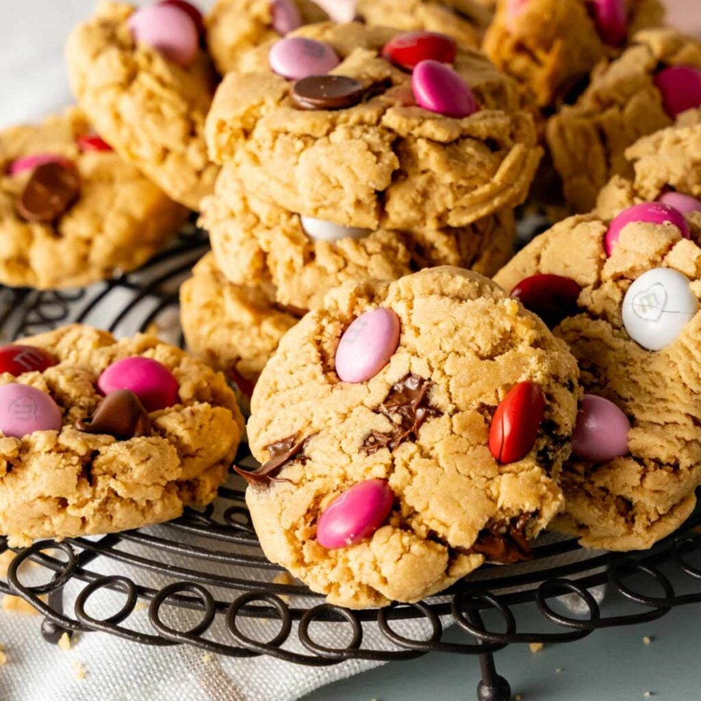 Peanut Butter M&M Cookies stacked on a decorative round rack with Valentine's day M&M's.