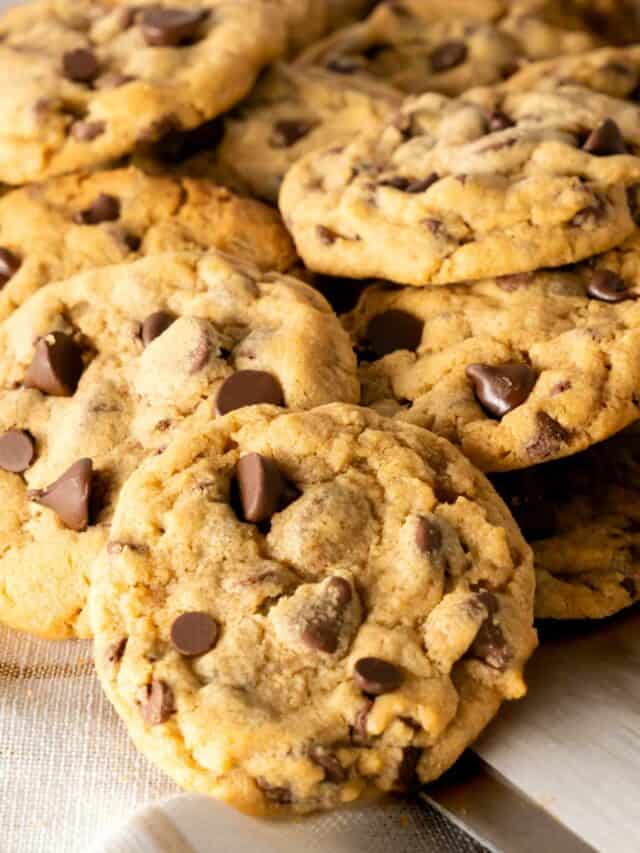 Chocolate Chip Cookie Butter Cookies stacked on top of each other with a white background.